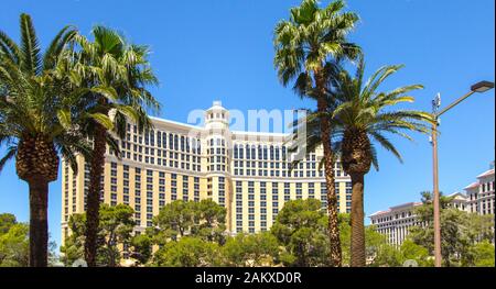 Las Vegas, Nevada, USA - Panorama of the Bellagio Resort exterior surrounded by palm trees with fountain in the foreground. Stock Photo