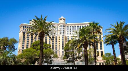 Las Vegas, Nevada, USA - Panorama of the Bellagio Resort exterior surrounded by palm trees with fountain in the foreground. Stock Photo