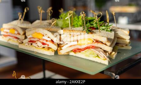 Close-up of fresh club sandwich. Concept of  takeaway food, restaurant and catering service Stock Photo