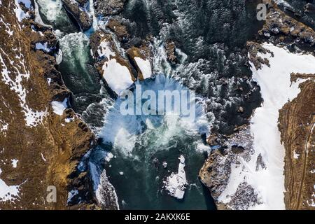 Aerial view of Godafoss waterfall, snowy shore and river. Iceland in early spring Stock Photo