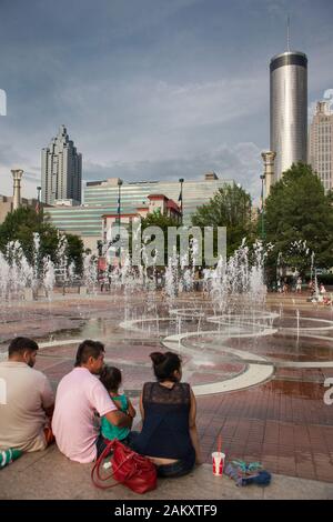 Vertical shot of a family enjoying the sound show at Centennial Olympic Park fountain, Downtown Atlanta, Georgia, USA Stock Photo