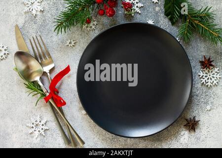 Elegant Christmas table setting. Festive and cutlery with Christmas decor on festive table. Top view flat lay. Stock Photo