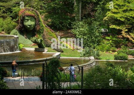Two visitors contemplate the woman sculpture of the Cascades Garden in the Botanical Garden, Piedmont Park, Midtown Atlanta, Georgia, USA Stock Photo