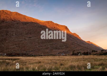 A full frame braketed hdr image of the winter sun setting on the Torridon mountains Liathach and Beinn Eighe, Wester Ross, Scotland. 31 December 2019 Stock Photo