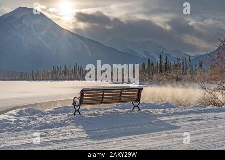 Winter bench at Vermilion Lakes in Banff National Park, Alberta, Canada Stock Photo