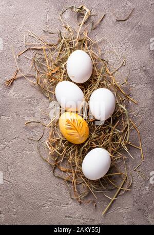Easter painted chicken golden egg Stock Photo