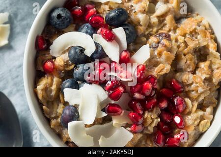 Hot Cooked Muesli Oatmeal with Berries and Coconut Stock Photo