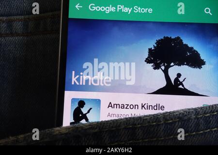 Kindle app on Google Play Store website displayed on smartphone hidden in jeans pocket Stock Photo