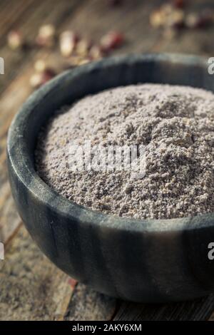 Raw Blue Organic Cornmeal Flour in a Bowl Stock Photo