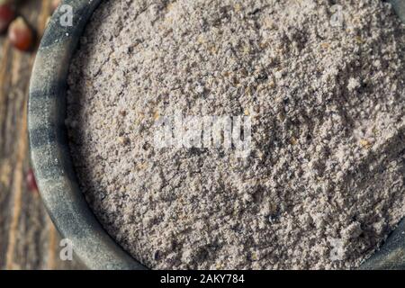 Raw Blue Organic Cornmeal Flour in a Bowl Stock Photo