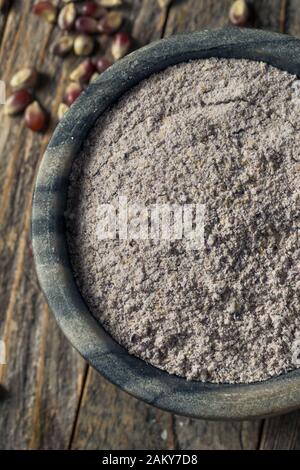 Raw Blue Organic Cornmeal Flour in a Bowl Stock Photo