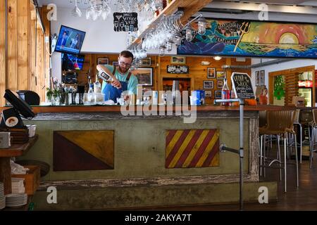 Bartender pouring a mixed alcoholic drink using Jack Daniel's bourbon whisky in restaurant / bar in Fairhope Alabama, United States. Stock Photo