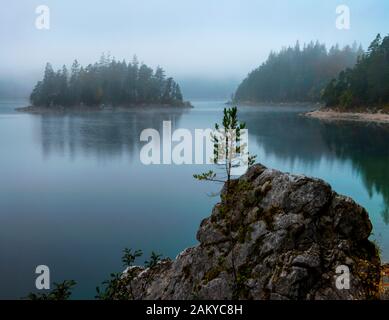 Foggy Eibsee and Zugspitz mountain in morning sun Stock Photo