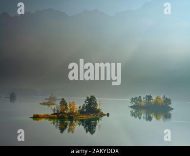 Foggy Eibsee and Zugspitz mountain in morning sun Stock Photo