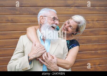 Happy fashion seniors couple embracing outdoor - Mature elegant people laughing and having a tender moment together Stock Photo