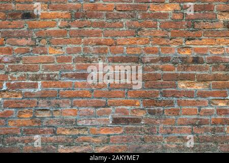 Weathered old red brick background with rough surface. Stock Photo