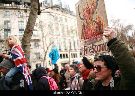 Protester holds a placard during a demonstration by members of the climate change activist movement Extinction Rebellion (XR) against Australian government's response to its ongoing bush fires outside the Australian High Commission in London.Wildfires have burned more than 12 million acres of Australian land since September last year, with the states of New South Wales and Victoria most severely affected and with the fire season still far from over. Australian Prime Minister Scott Morrison is facing intense criticism over his handling of the crisis, including his decision to go on holiday to H Stock Photo