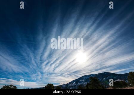 Unusual cloud formations against clear cobalt blue sky; central Colorado; USA Stock Photo
