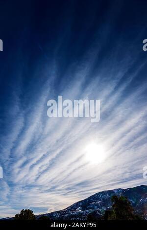 Unusual cloud formations against clear cobalt blue sky; central Colorado; USA Stock Photo