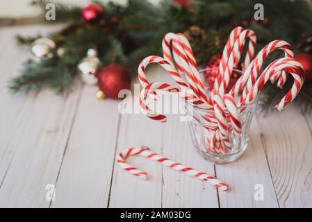 https://l450v.alamy.com/450v/2am03dg/glass-full-of-candy-canes-against-a-christmas-backdrop-2am03dg.jpg