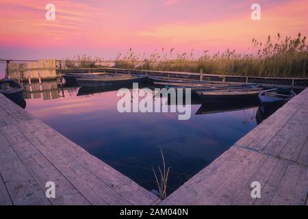 View of boats at sunset in Delta del Ebro Natural Park Stock Photo