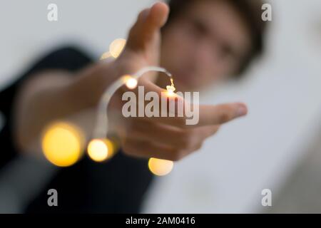 LED Light string cover arm of young man Stock Photo