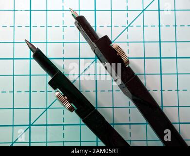 Drawing compass on a geometric background. Macro image Stock Photo