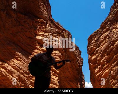 A man playing guitar at the Anphitheatre on the Salta Cafayate road,  Argentina Stock Photo