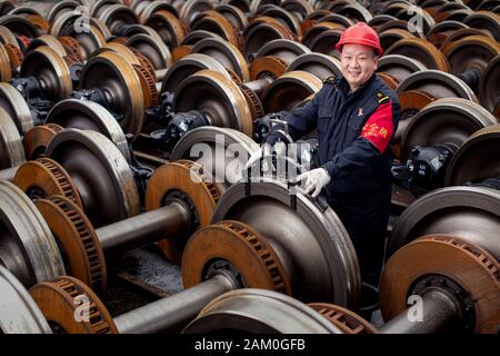 (200111) -- WUHAN, Jan. 11, 2020 (Xinhua) -- Liu Wei, a train wheel quality inspector, poses for a photo at the Wuchang Depot of China Railway Wuhan Group Co., Ltd. in Wuhan, central China's Hubei Province, Jan. 7, 2020. China, the world's most populated country, on Jan. 10 ushered in its largest annual migration, 15 days ahead of the Spring Festival, or the Lunar New Year. This year, three billion trips will be made during the travel rush from Jan. 10 to Feb. 18 for family reunions and travel, according to official forecast. The 40-day travel rush is known as Chunyun in Chinese. The Lunar Stock Photo