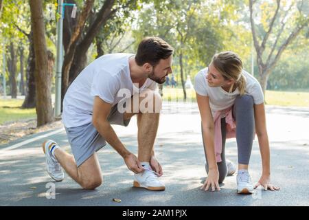 Couples preparing to exercise in the morning at the park. Couples are wearing shoes to exercise. Stock Photo