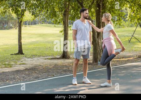 Couples preparing to exercise in the morning at the park. Stock Photo