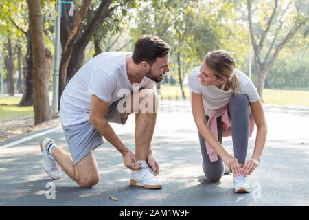 Couples preparing to exercise in the morning at the park. Couples are wearing shoes to exercise. Stock Photo