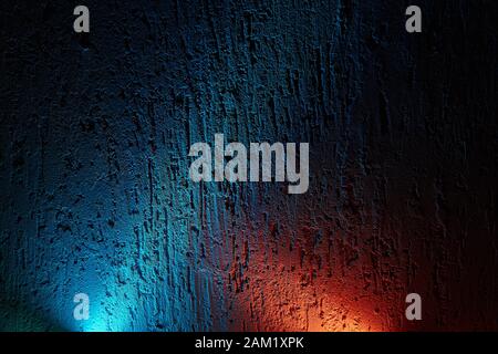 On a dark background the intersection of the rays of the blues and red Stock Photo