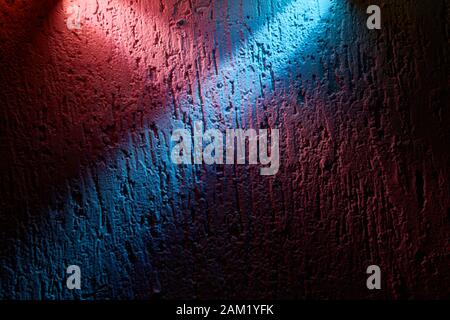 Light blue beam overlaps the pink beam on a textural background Stock Photo