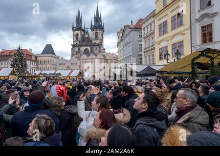 Prague in the Czech Republic on December 23 2019 a crowd of people wait for the ancient clock to strike on the tower. editorial Stock Photo