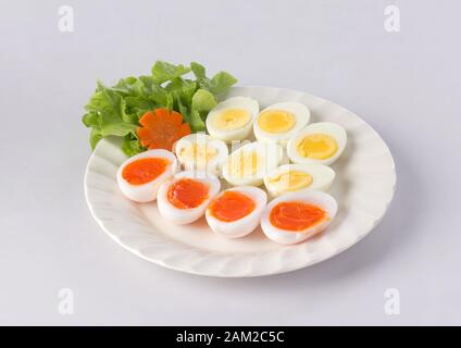 Soft boiled duck eggs and hard boiled eggs on the dish isolated on white background Stock Photo