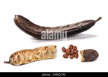 Carobs pod with beans isolated on white background Stock Photo