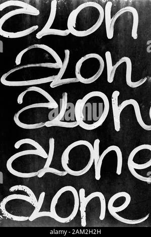 Word 'alone' written on black grungy wall. It can be used as a poster, wallpaper, design t-shirts and more. Stock Photo