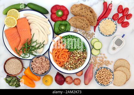 Low GI health food for diabetics with blood sugar testing monitor with foods high in vitamins, minerals, anthocyanins, antioxidants & smart carbs. Stock Photo