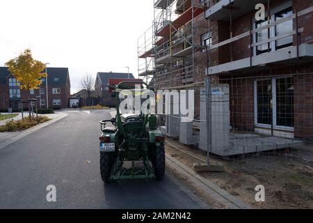 Digger parked beside apartments being built in new town, Borschemnich Neu, Germany Stock Photo