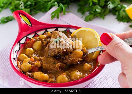 Famous Moroccan soup harira with meat, chickpeas, lentils, tomatoes and spices. Hearty, fragrant. Preparing for Iftar in the holy month of Ramadan Stock Photo