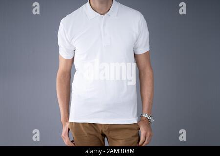 Midsection Of Man In Casuals Standing Against Gray Background Stock Photo