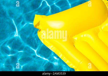 Empty inflatable raft in bright floating on blue swimming pool in ...
