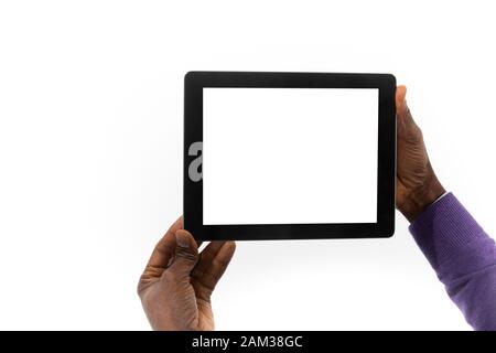 View from behind of an African man holding a tablet computer in his hands Stock Photo