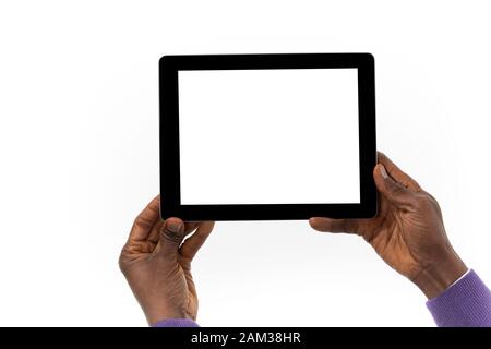 View from behind of an African man holding a tablet computer in his hands Stock Photo