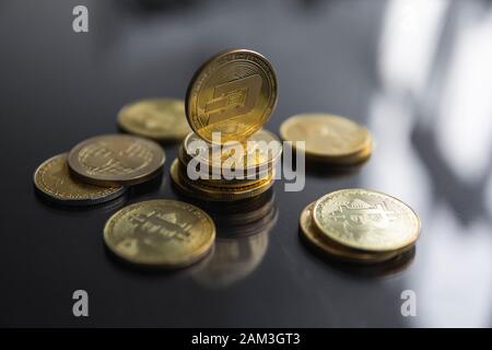 Stack of golden Dash bitcoin coin with a lot of bitcoins coins on a table. Virtual cryptocurrency concept. Mining of bitcoins online bussiness Stock Photo