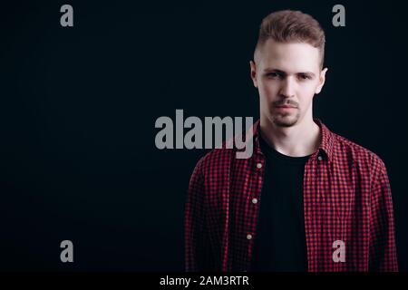 Calm Pensive Young Man in Checkered Shirt Stock Photo