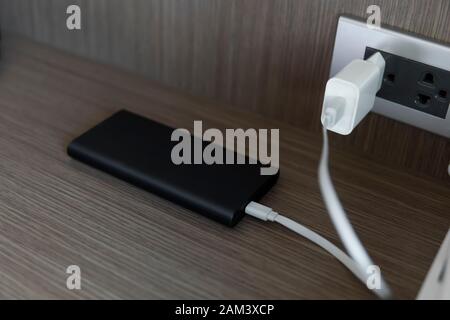 Charging of power bank. Power-saving device for smartphone and other devices. Helping to charge your phone. Stock Photo