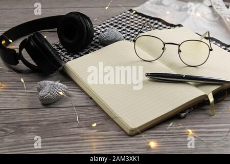 Leather handbag, clean blank notepad, pen, glasses, watch on a wooden background, top view. Free space for text. Workplace business background Stock Photo