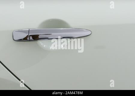 Modern white car door handle.Car door handle is an external part of the car. Stock Photo